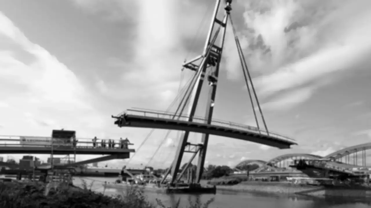 A crane lifting a bridge section over water