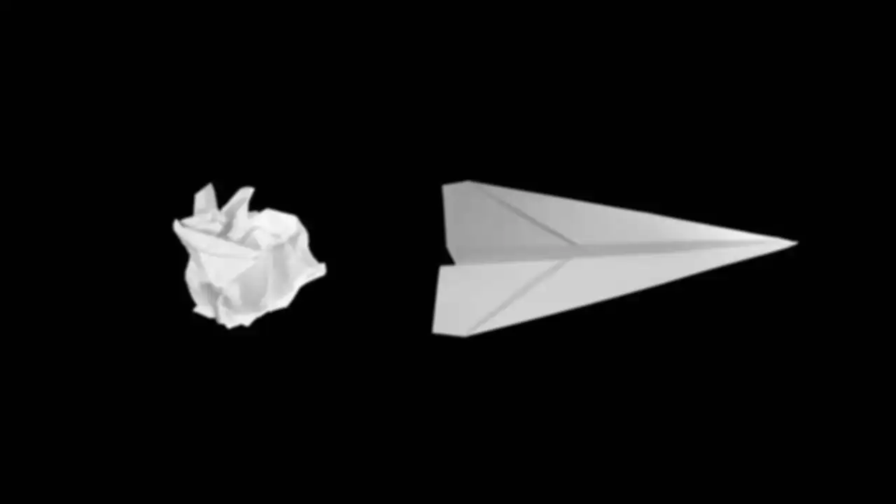 A paper airplane and a crumpled paper ball